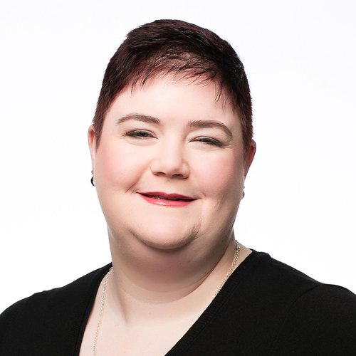 Ashleigh Lodge, smiling, with short dark hair, in a black top