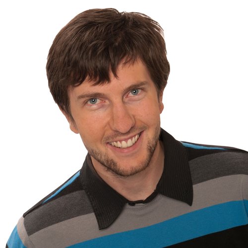 Barrett Telfer, smiling, with short brown hair, in a striped sweater