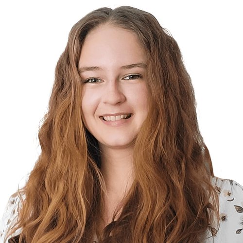 Maria Volkova, smiling, with long, wavy light brown hair, in a patterned white blouse
